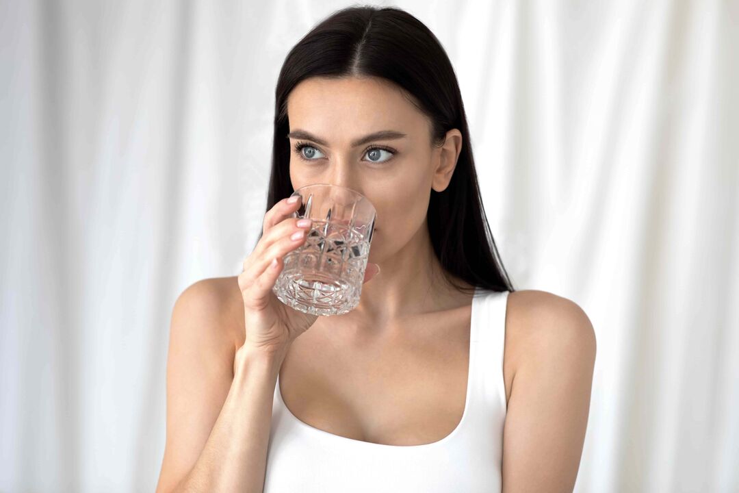 Girl drinks water for weight loss with proper diet